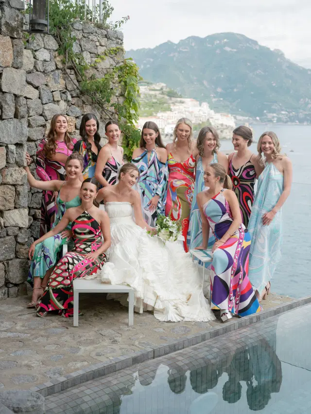 Bride surrounded by bridesmaids in colorful Pucci dresses overlooking the Amalfi Coast at an Easton Events wedding.
