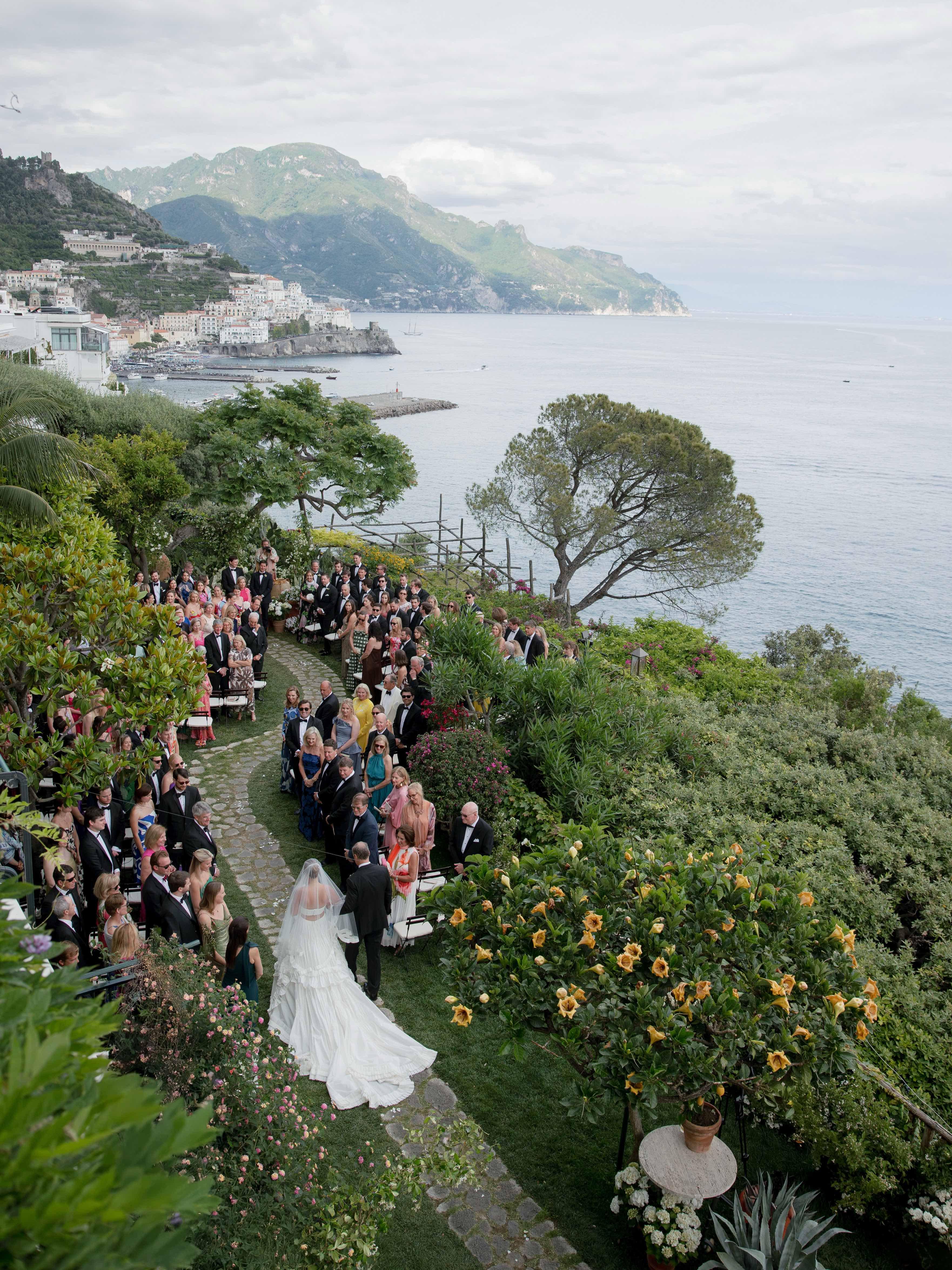 Bride walking down the aisle at an Easton Events wedding overlooking the Amalfi Coast in Italy.