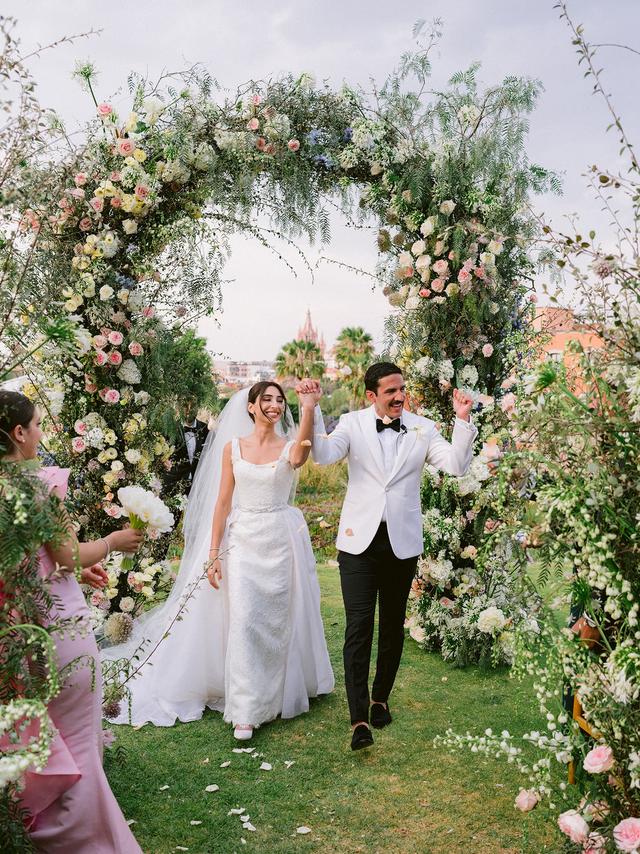 Aerial view of a garden wedding ceremony overlooking the colorful architecture of San Miguel de Allende, Mexico.